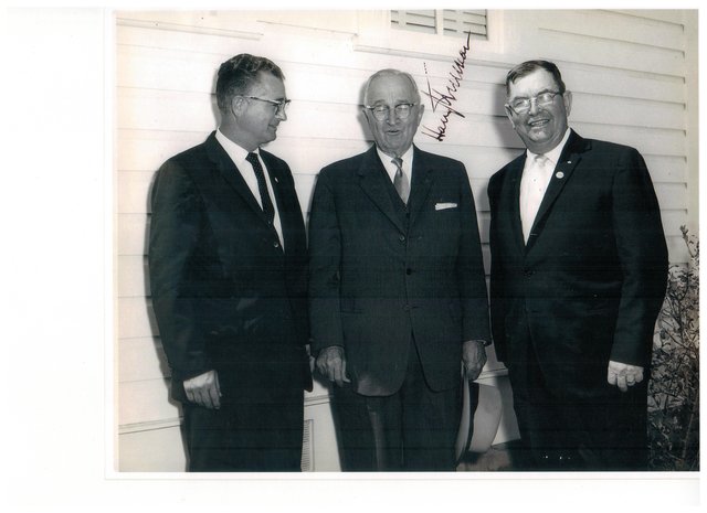 The wider print of the same photograph, showing an unidentified third man standing beside Truman and Gillen