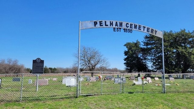 The iron arch over the entrance to Pelham Cemetery, Est. 1890
