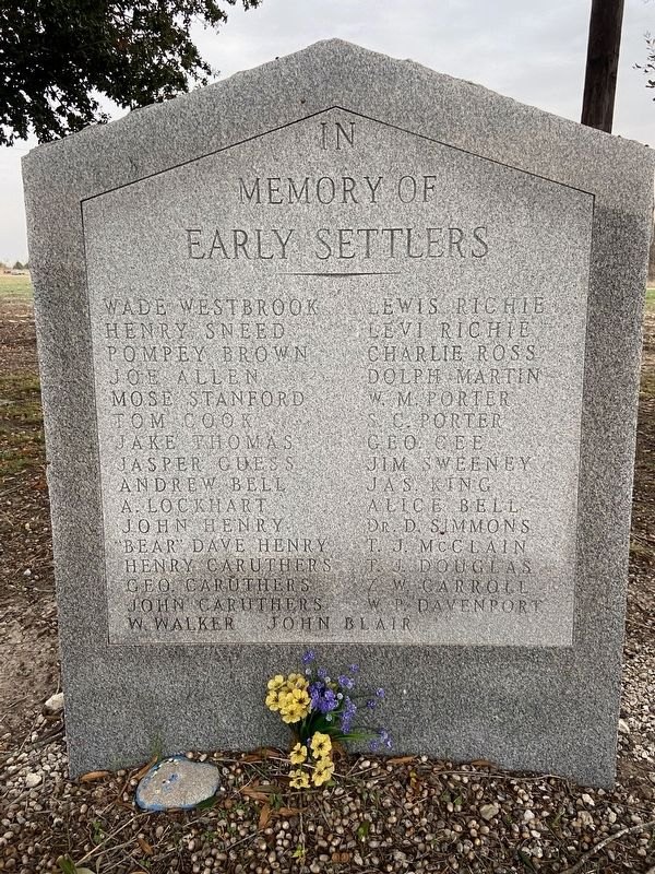 A granite stone in memory of the early settlers of the Pelham community, listing family names