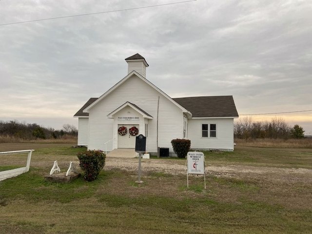 Wesley Chapel Methodist Church at Pelham, a small white frame church with a state historical marker beside it