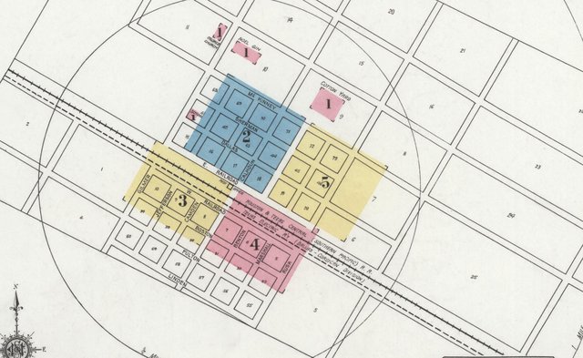 The 1921 Sanborn key map of Rice: numbered blocks in color either side of two parallel railroad lines running diagonally across the town