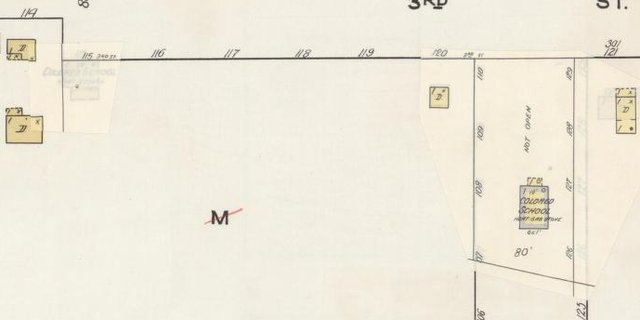 Detail of the 1934 fire-insurance map: the lot of the 1921 school is pasted over and blank, and a new building labelled Colored School stands farther east