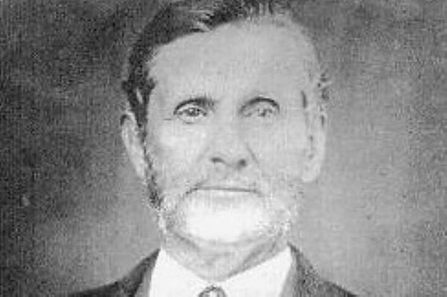 Portrait photograph of Walter P. Lane in later life, white-bearded, in a dark coat